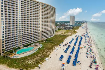 an overhead view of a beach with umbrellas and the ocean at Flipflop Paradise Unit 625 in Panama City Beach