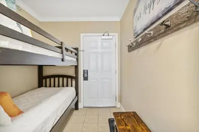 a bedroom with two bunk beds and a table at Flipflop Paradise Unit 625 in Panama City Beach