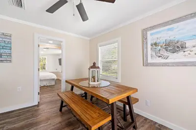 a dining room with a table and a bench at Endless Summer's 514 in Panama City Beach
