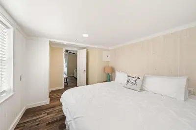 a white bedroom with a large bed with white pillows at Endless Summer's 514 in Panama City Beach