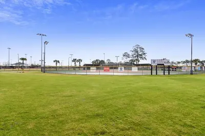 a baseball field with green grass and lights on it at Endless Summer's 514 in Panama City Beach