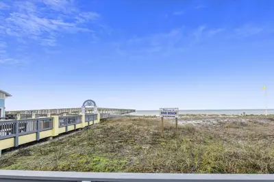 a beach with a sign in front of the ocean at Endless Summer's 514 in Panama City Beach