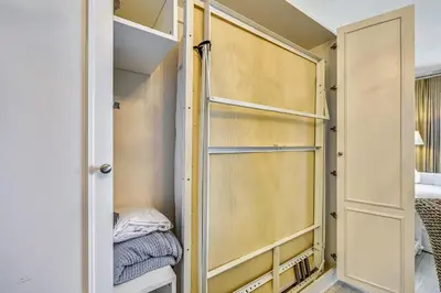 a closet with a door open to a bedroom at Twin Palms Resort #1404 by Book That Condo in Panama City Beach