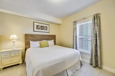 a bedroom with a bed and a window at Twin Palms Resort #1404 by Book That Condo in Panama City Beach