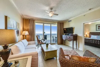 a living room with a couch and a tv at Twin Palms Resort #1404 by Book That Condo in Panama City Beach