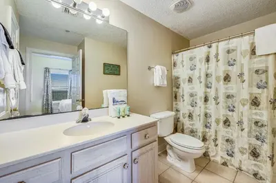 a bathroom with a sink and a toilet and a shower at Twin Palms Resort #1404 by Book That Condo in Panama City Beach