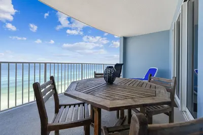 a table and chairs on a balcony with a view of the ocean at Twin Palms Resort #1404 by Book That Condo in Panama City Beach