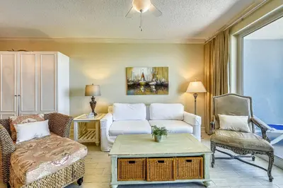 a living room with a couch and a chair at Twin Palms Resort #1404 by Book That Condo in Panama City Beach