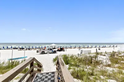 a view of the beach with a checkered boardwalk at Emerald Beach #1426 by Book That Condo in Panama City Beach