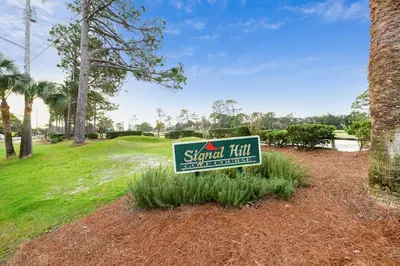 a sign for astand firm on a golf course at Emerald Beach #1426 by Book That Condo in Panama City Beach