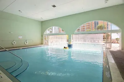 a large swimming pool with a dog in the water at Celadon Beach Resort #1104 by Book That Condo in Panama City Beach
