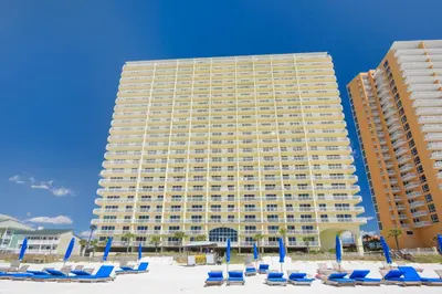 a large building with beach chairs and blue condos at Celadon Beach Resort #1104 by Book That Condo in Panama City Beach