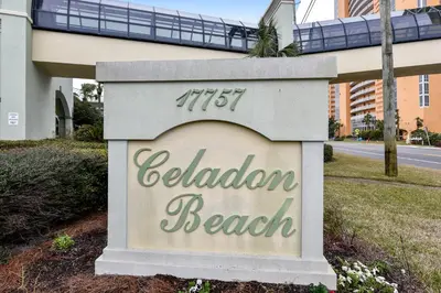 a sign for a hotel with a train in the background at Celadon Beach Resort #1104 by Book That Condo in Panama City Beach