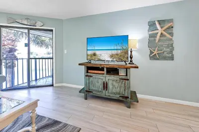 a living room with a desk with a computer on it at Edgewater Golf Villa 1409 in Panama City Beach