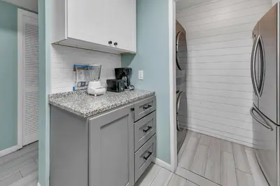 a kitchen with a counter and a refrigerator at Edgewater Golf Villa 1409 in Panama City Beach