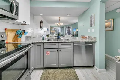 a kitchen with a sink and a counter top at Edgewater Golf Villa 1409 in Panama City Beach