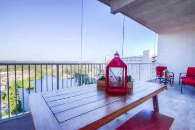 a red lantern sitting on a wooden table on a balcony at Large 3 Bd Penthouse 2034 In Laketown, Great Views and Amenities! in Panama City Beach