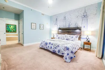 a bedroom with a large bed and a brick wall at Large 3 Bd Penthouse 2034 In Laketown, Great Views and Amenities! in Panama City Beach