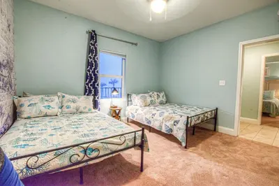 a bedroom with two beds and a window at BEAUTIFUL 3 BD Laketown Wharf 1133- Best Amenities! in Panama City Beach