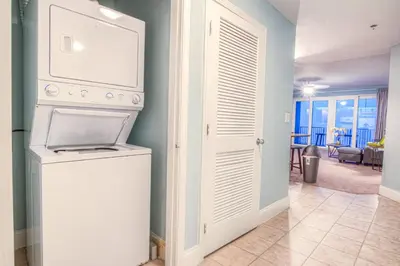 a kitchen with a washer and dryer in a room at BEAUTIFUL 3 BD Laketown Wharf 1133- Best Amenities! in Panama City Beach