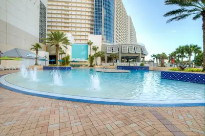 a large pool with water fountain in a mall at BEAUTIFUL 3 BD Laketown Wharf 1133- Best Amenities! in Panama City Beach