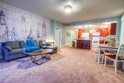 a living room with a couch and a kitchen at BEAUTIFUL 3 BD Laketown Wharf 1133- Best Amenities! in Panama City Beach