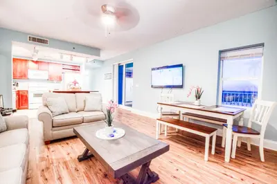 a living room with a couch and a table at Laketown Wharf 1238 - Brand New End Unit With Wrap Around Balcony in Panama City Beach