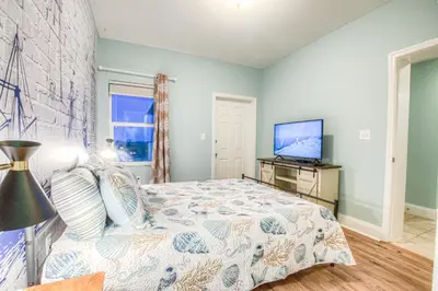 a bedroom with a bed and a flat screen tv at Laketown Wharf 1238 - Brand New End Unit With Wrap Around Balcony in Panama City Beach
