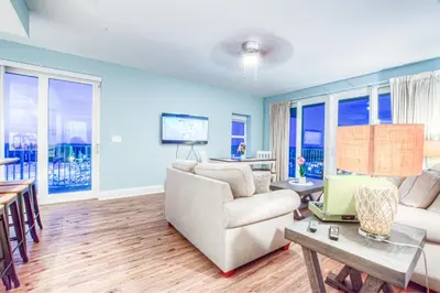a living room with a couch and a table at Laketown Wharf 1238 - Brand New End Unit With Wrap Around Balcony in Panama City Beach
