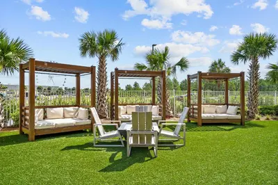a garden with a gazebo and a table and chairs at Calypso Tower 3 Beach Resort in Panama City Beach