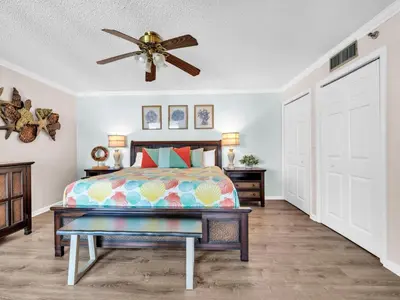 a bedroom with a bed and a ceiling fan at Watercrest 402 in Panama City Beach