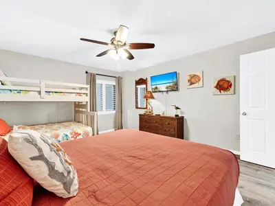 a bedroom with a bed and a ceiling fan at Watercrest 402 in Panama City Beach