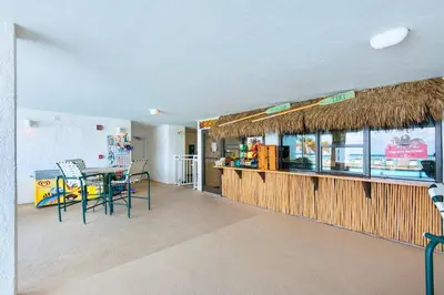 a dining room with a table and a counter at Watercrest 402 in Panama City Beach