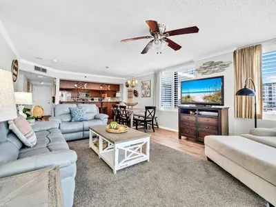 a living room with a couch and a tv at Watercrest 402 in Panama City Beach