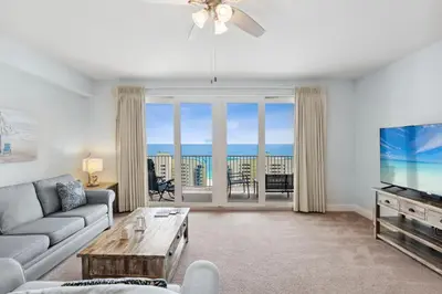 a living room with a couch and a tv at Spacious Resort Condo with Breathtaking Gulf Views! by Dolce Vita Getaways PCB in Panama City Beach