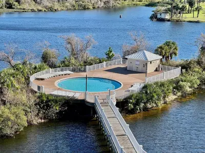 a bridge over a body of water with a swimming pool at Spacious Resort Condo with Breathtaking Gulf Views! by Dolce Vita Getaways PCB in Panama City Beach
