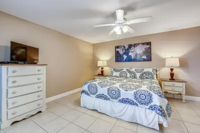 a bedroom with a bed and a ceiling fan at Watercrest #1206 by Book That Condo in Panama City Beach