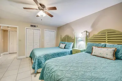 a bedroom with two beds and a ceiling fan at Watercrest #1206 by Book That Condo in Panama City Beach