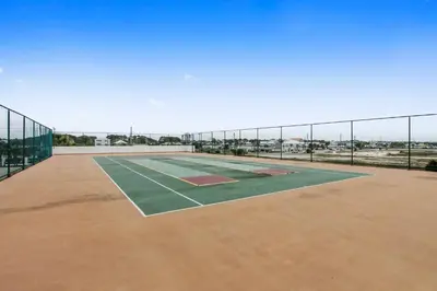 an indoor tennis court with a fence on top at Watercrest #1206 by Book That Condo in Panama City Beach