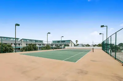 a tennis court in front of a building at Watercrest #1206 by Book That Condo in Panama City Beach