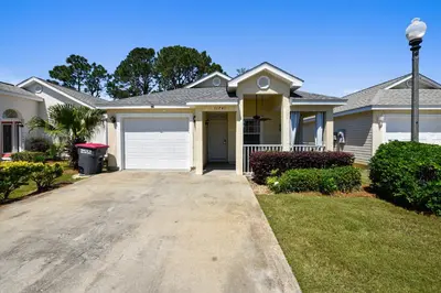 a house with a driveway in front of it at The Sandbox by Book That Condo in Panama City Beach