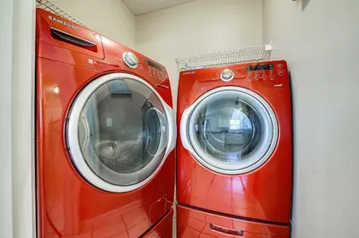 two washing machines sitting next to each other in a room at The Sandbox by Book That Condo in Panama City Beach