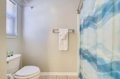 a bathroom with a toilet and a shower at The Sandbox by Book That Condo in Panama City Beach