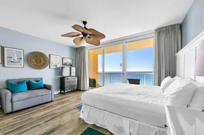 a bedroom with a bed and a ceiling fan at Majestic Beach Towers 1-2109 in Panama City Beach