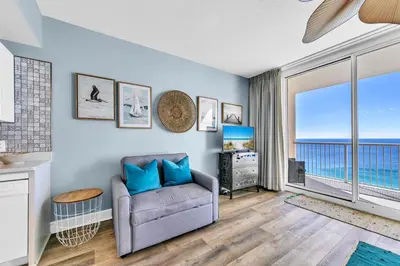 a living room with a couch and a view of the ocean at Majestic Beach Towers 1-2109 in Panama City Beach