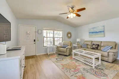a living room with a couch and a table at PCB Resort Condo with Private Balcony and 3 Pools! in Panama City Beach