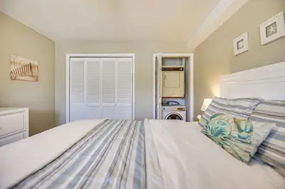 a bedroom with a bed and a window at PCB Resort Condo with Private Balcony and 3 Pools! in Panama City Beach