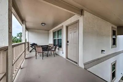 a balcony of a house with a table and chairs at PCB Resort Condo with Private Balcony and 3 Pools! in Panama City Beach
