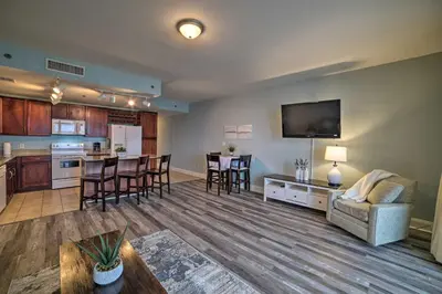 a large living room with a couch and a kitchen at 18th-Floor PCB Resort Condo with Amazing Gulf View! in Panama City Beach