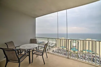 a balcony with a table and chairs and a view of the ocean at 18th-Floor PCB Resort Condo with Amazing Gulf View! in Panama City Beach